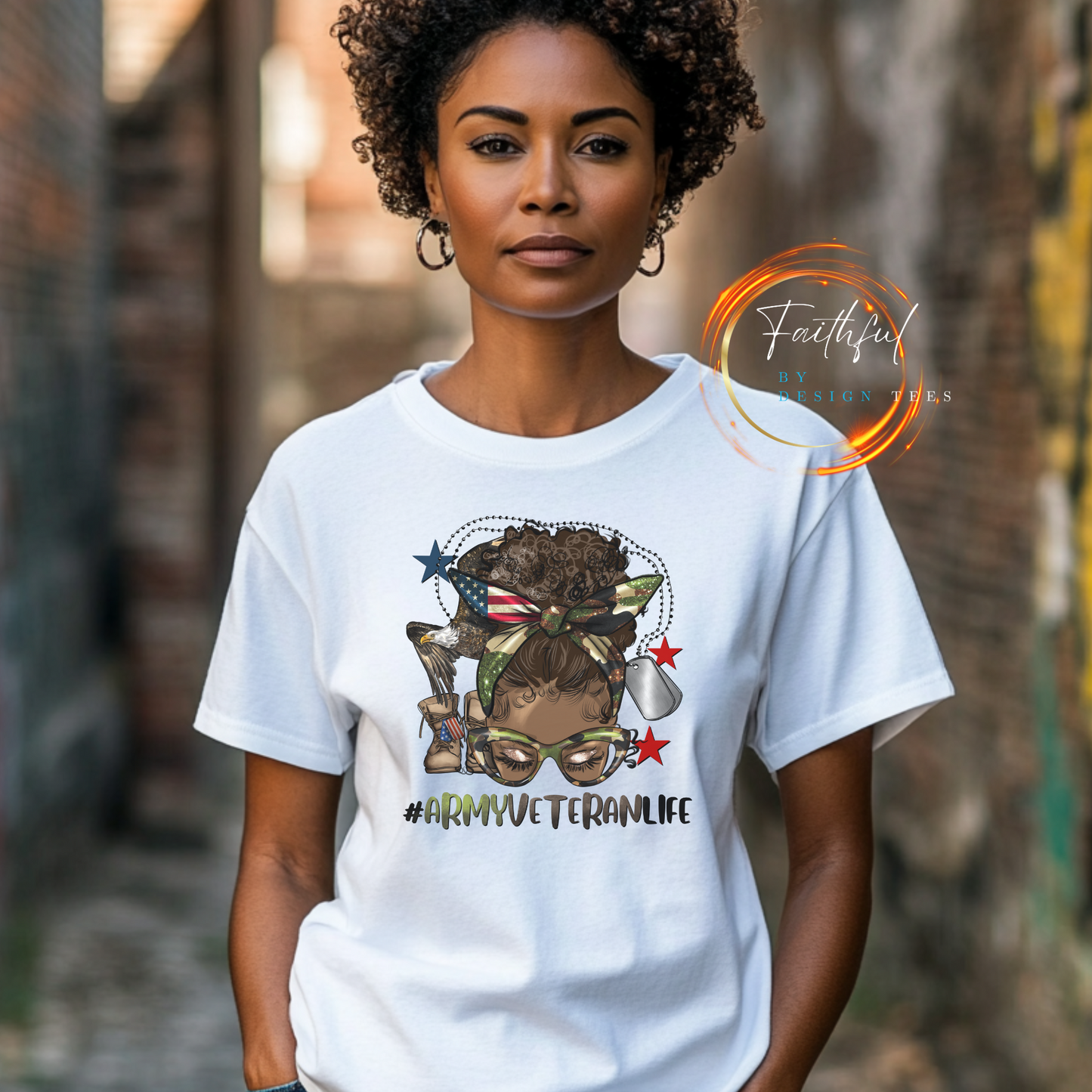 White bella canvas shirt with an african american woman with a messy afro bun on the front. Under the picture it says #armyveteranlife. Dog tags and combat boots are in the background of the picture