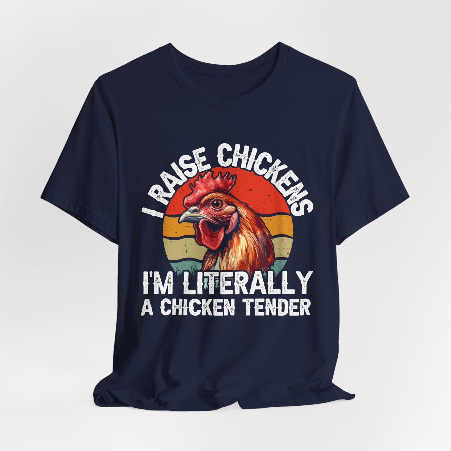 navy blue shirt with I raise chickens I'm Literally a chicken tender on the front in distressed print. There is a rooster in the design. 